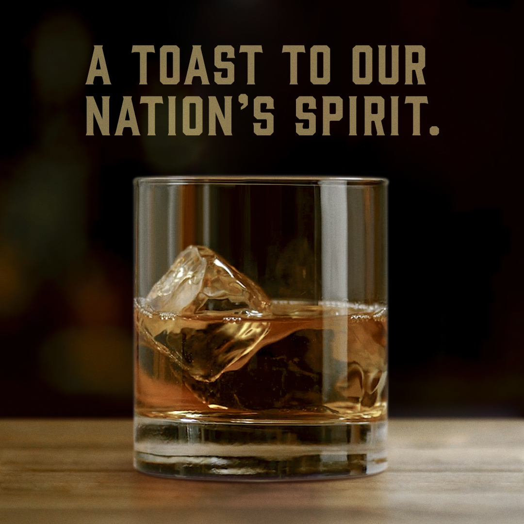 glass of bourbon with text "A toast to our nation's spirit."